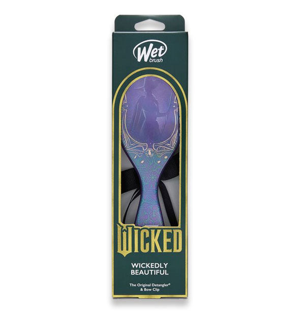 Wicked edition Wet Brush in Wickedly Beautiful design features an purple brush paddle with Elphaba's silhouette and a black hair bow partially visible through window in packaging