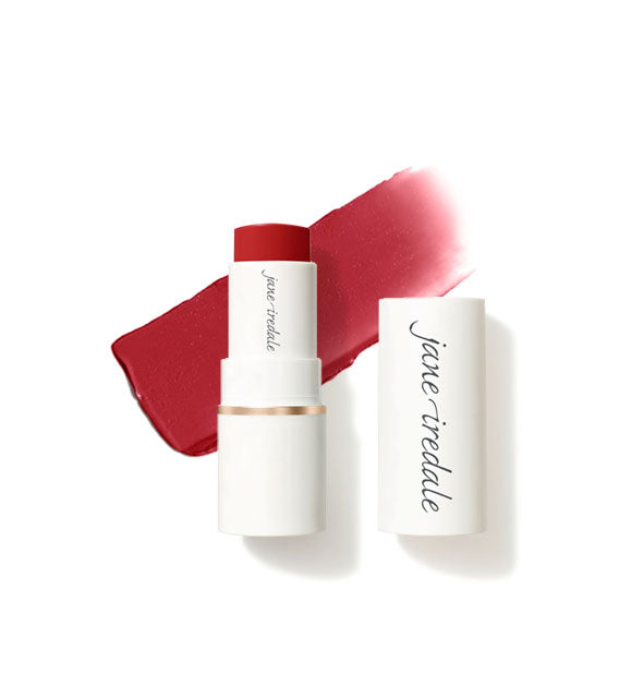White tube of Jane Iredale Glow Time Blush Stick with cap removed and sample product application behind in matte shade Ember