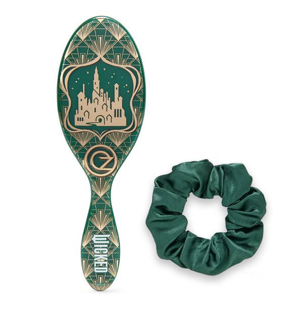 Green and gold art deco-style Wicked Wet Brush Paddle with Emerald City image next to a matching green hair scrunchie