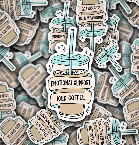 Pile of stickers illustrated to resemble cups with straws accented by stars with wrap-around banners that say, "Emotional Support Iced Coffee" in black lettering