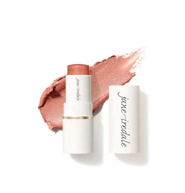 White tube of Jane Iredale Glow Time Blush Stick with cap removed and sample product application behind in shimmery shade Enchanted