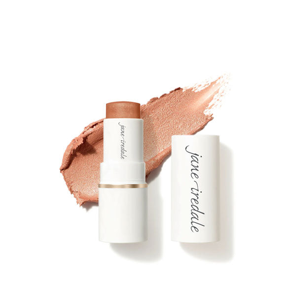 White tube of Jane Iredale Glow Time Blush Stick with cap removed and sample product application behind in shimmery shade Ethereal
