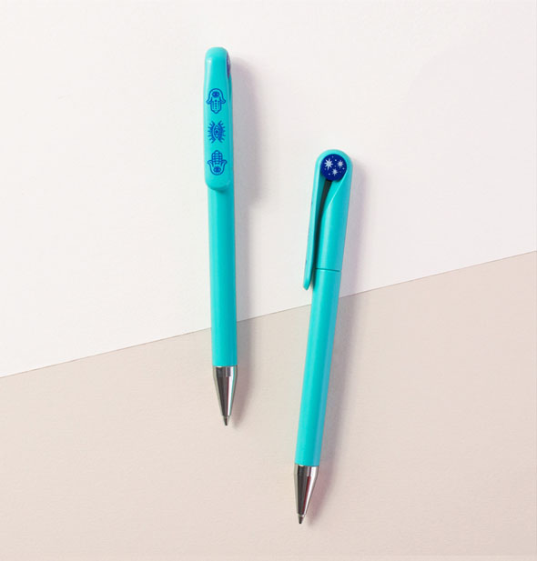 Blue pens with dark blue evil eye symbols on the top and clip
