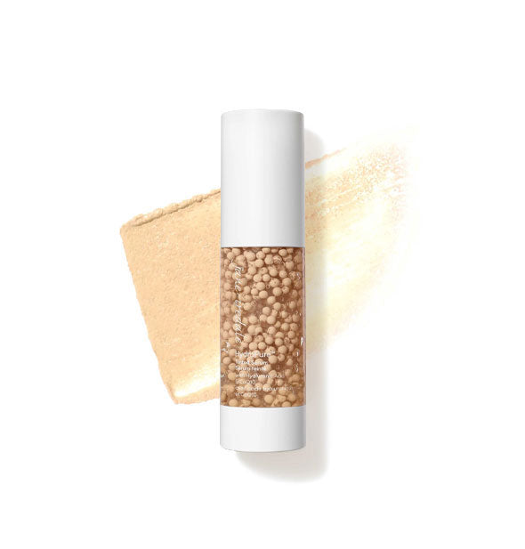 Bottle of Jane Iredale HydroPure Tinted Serum with color capsules visible through clear packaging and a sample application behind in the shade Fair 1