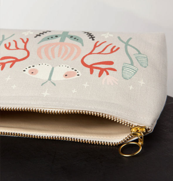 Closeup of the zipper on an opened Far and Away Small Cosmetic Bag