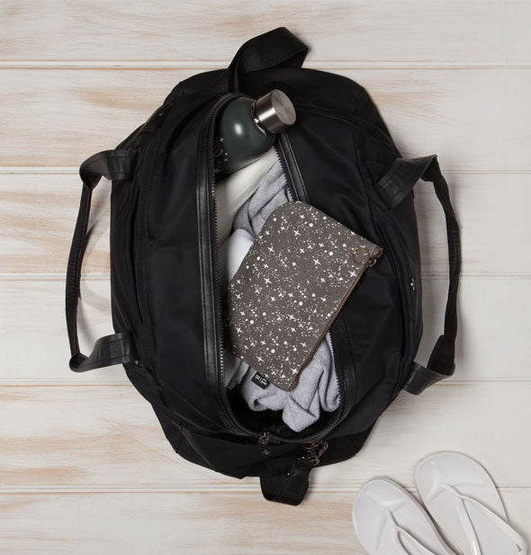 Starry sky pouch rests on top of an opened gym bag