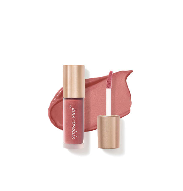 Tube of Jane Iredale Beyond Matte Lip Stain with separate gold doe foot applicator cap rest atop an enlarged sample application of product in shade Fascination