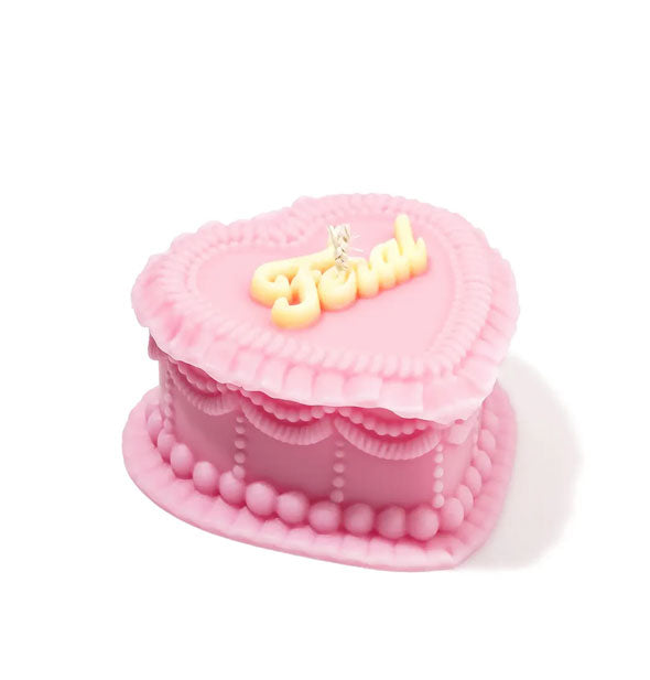 Another view of the pink Feral heart-shaped cake candle shows its ornate "icing" on the side