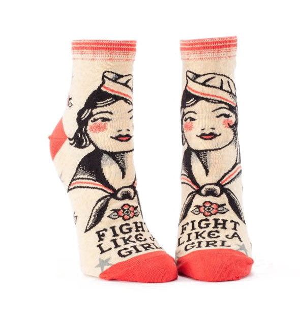 Pair of light-colored socks with peach accents each feature a vintage female sailor above the words, "Fight Like a Girl"