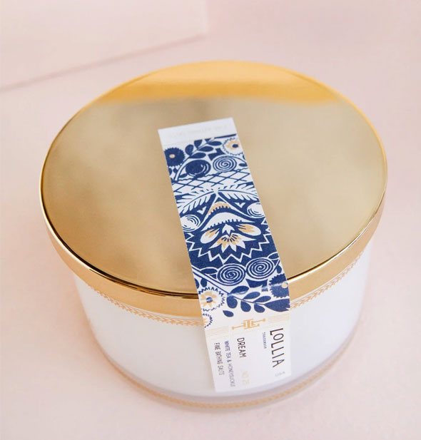 Top of a Lollia bath salts container shows blue floral sticker label detail