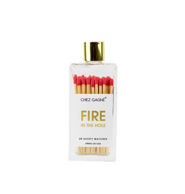 Rectangular glass bottle containing 40 red-tipped Chez Gagné safety matches and topped with a gold lid says, "Fire in the hole" in gold foil