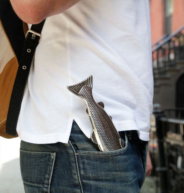 Silver fish flask is stuffed into a model's jeans pocket