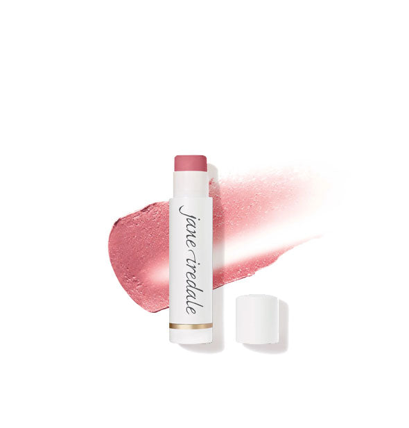 White tube of Jane Iredale lip balm with cap removed overtop a sample application of product in a pink shade