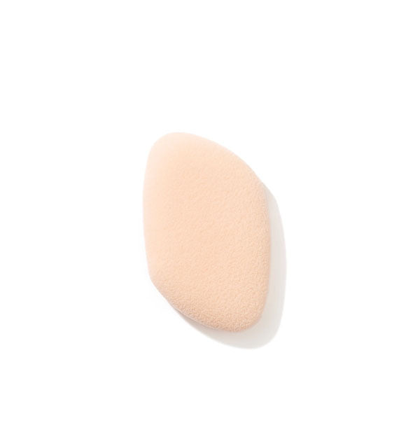 Light peachy-pink rounded trapezoidal makeup sponge