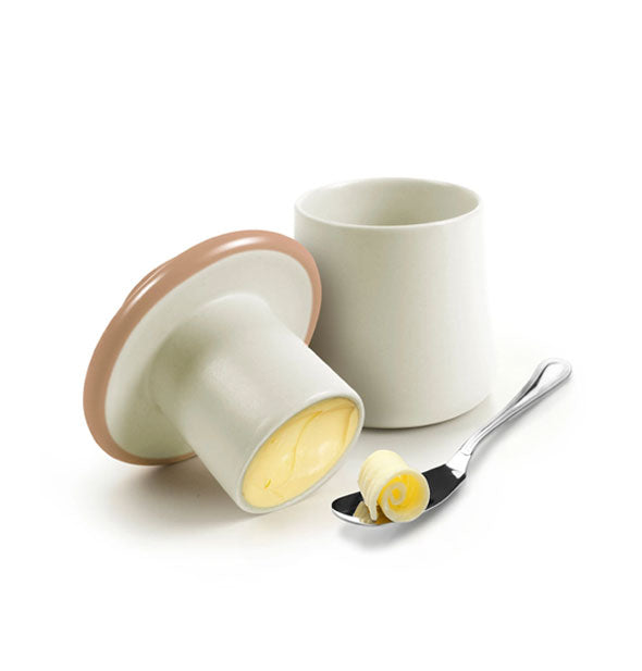 Ceramic mushroom butter storage container staged with butter and silver spoon