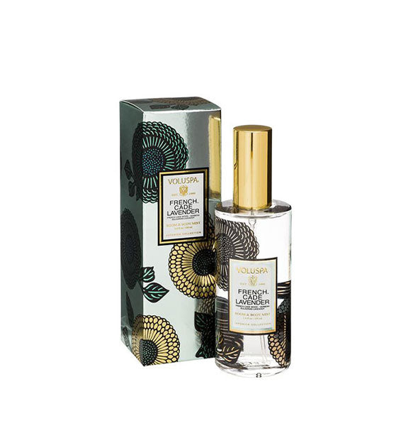 Floral-patterned clear glass bottle of Voluspa French Cade Lavender Room & Body Mist next to silver gift box with black and gold floral pattern