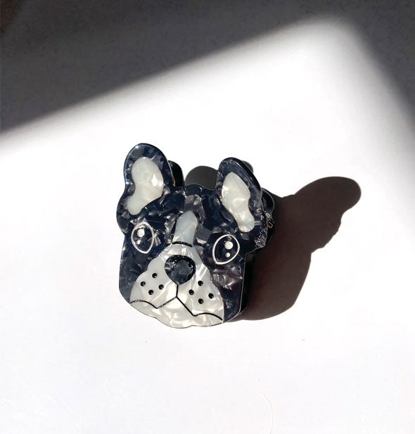 Black and white quartz-effect French bulldog face hair clip with painted eyes, nose, mouth, and whisker details