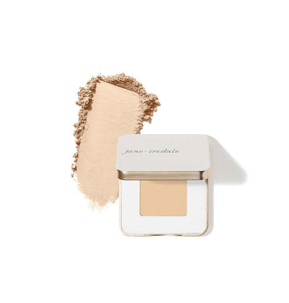 Opened square white and gold Jane Iredale eye shadow compact with sample product application at left in the shade French Vanilla