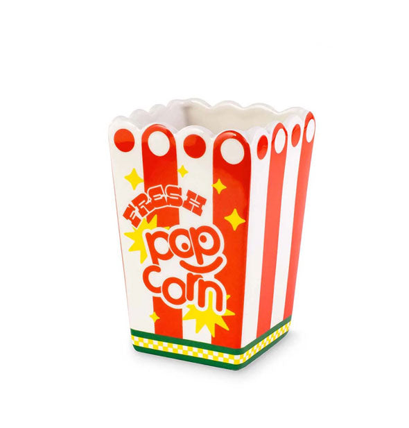 Red and white striped ceramic vase with green stripes at bottom, yellow accents, and a scalloped edge is designed to resemble a popcorn container and says, "Fresh Popcorn" on the side in fun lettering