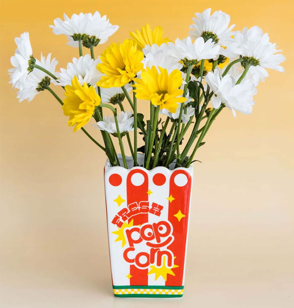 Fresh Popcorn vase holds a bunch of yellow and white daisies