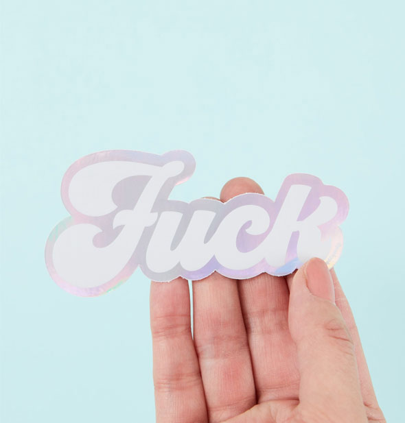 Model's hand holds a holographic "Fuck" sticker