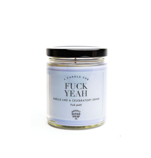 A Candle for Fuck Yeah (Smells Like a Celebratory Drink) by Whiskey River Soap Co. in a clear glass vessel with black lid