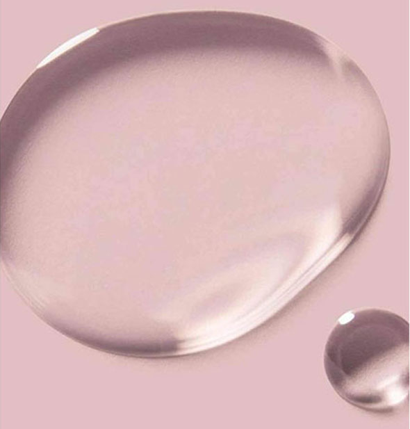 Sample droplets of Verb Ghost Oil on pink surface
