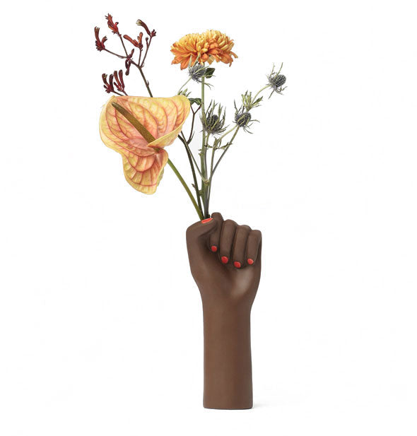 Raised fist vase holds an assortment of flowers