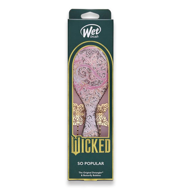 Wicked edition Wet Brush in So Popular design features an ornate pink brush paddle and two golden butterfly bobby pins partially visible through window in packaging