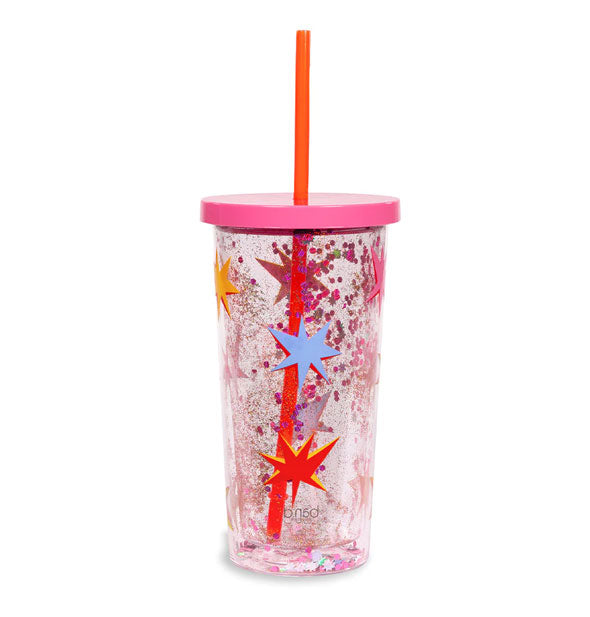 Clear acrylic drink tumbler with pink lid and red straw features floating glitter in its walls and an exterior multicolor starburst pattern