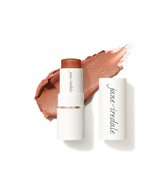 White tube of Jane Iredale Glow Time Blush Stick with cap removed and sample product application behind in shimmery shade Glorious