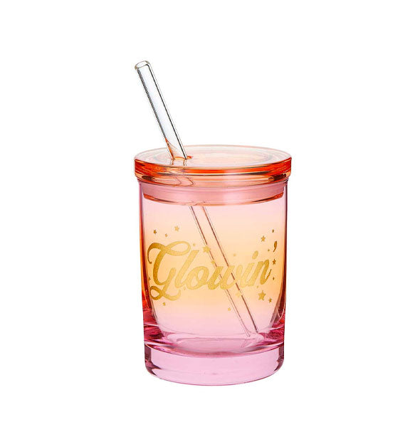 Pink-to-red ombre glass tumbler with lid and straw says, "Glowin'" in gold script surrounded by small stars