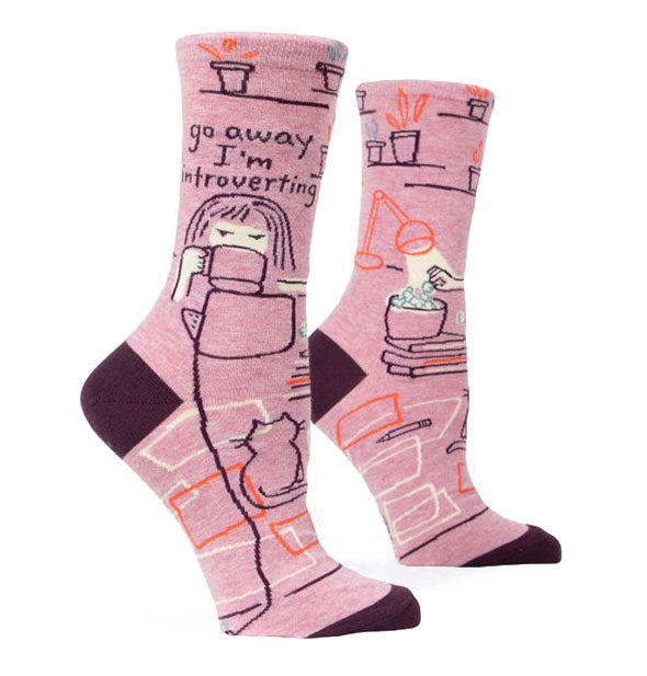 Pair of pink crew socks with dark heels and toes features woven illustration and the phrase, "Go away I'm introverting."