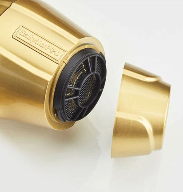 Closeup of the nose of the Gold FX BaBylissPRO Turbo hair dryer with nozzle removed to show black filter underneath