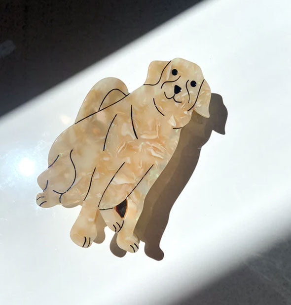 Hair clip designed and painted to resemble a golden retriever with quartz-like swirled effect and black accent lines