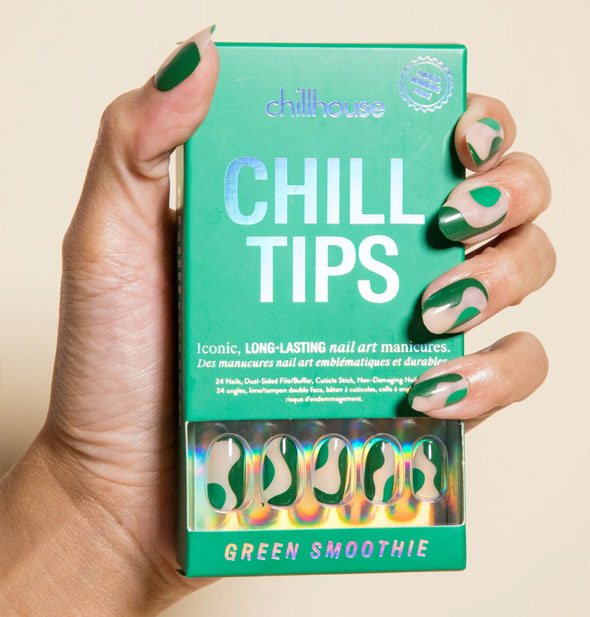 Model's hand wearing Green Smoothie Chillhouse press-on nails holds a green box of the same design with iridescent lettering and nail samples visible through a window in the packaging
