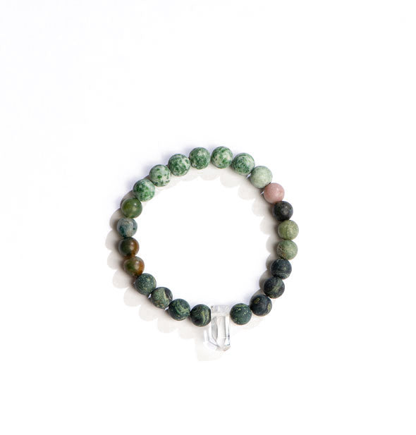 Beaded bracelet with green and earthy stones accented with a central clear crystal point