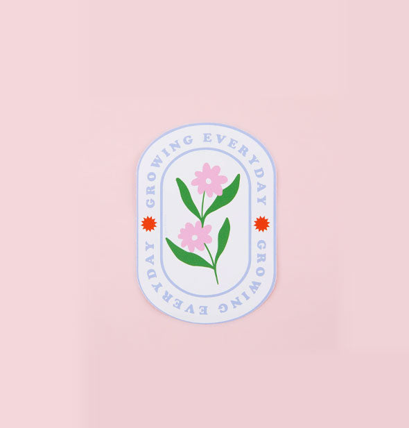 Elongated white sticker says, "Growing Everyday" twice with red star accents in a border around two pink flowers with green leaves