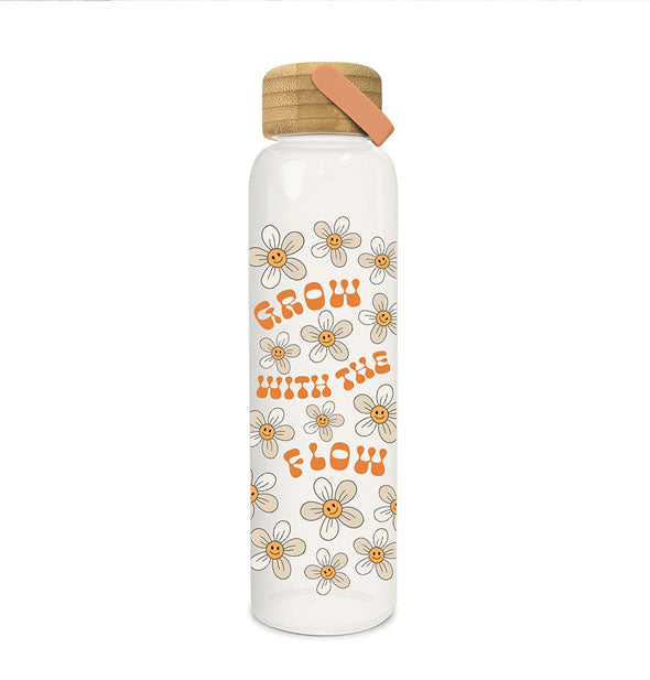 Tall clear class water bottle with bamboo lid and orange handle says, "Grow with the flow" in orange lettering surrounded by smiling daisies