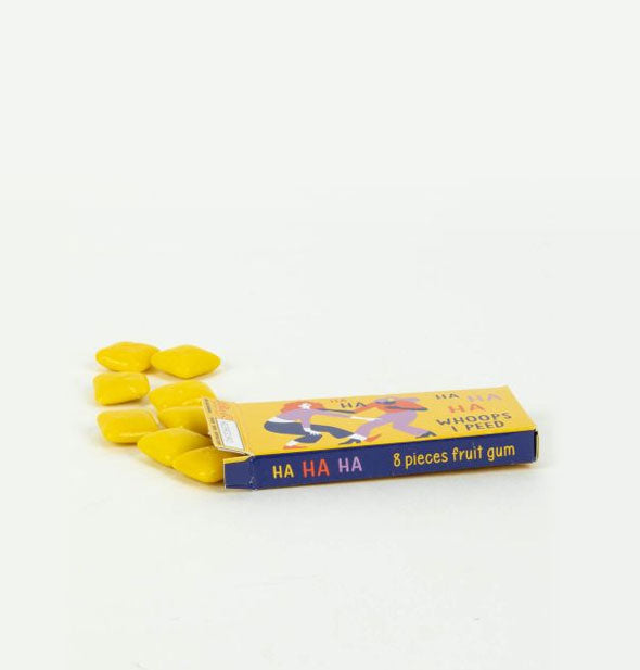 Slim box on its side spills out pieces of yellow chewing gum