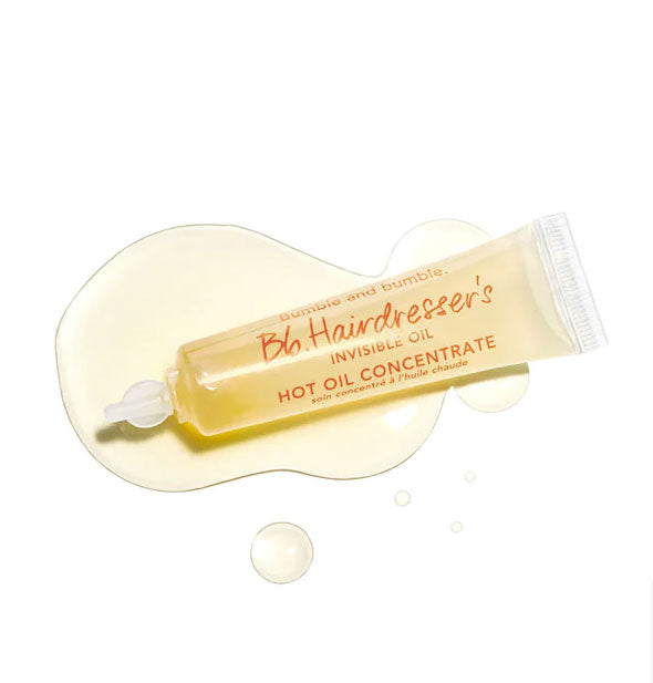 Tube of Bumble and bumble Hairdresser's Invisible Oil Hot Oil Concentrate with some product dispensed to show color and consistency