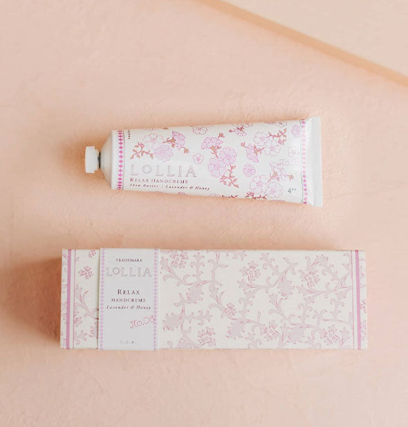 White tube and box of Lollia Relax Handcreme both feature delicate pink floral patterning