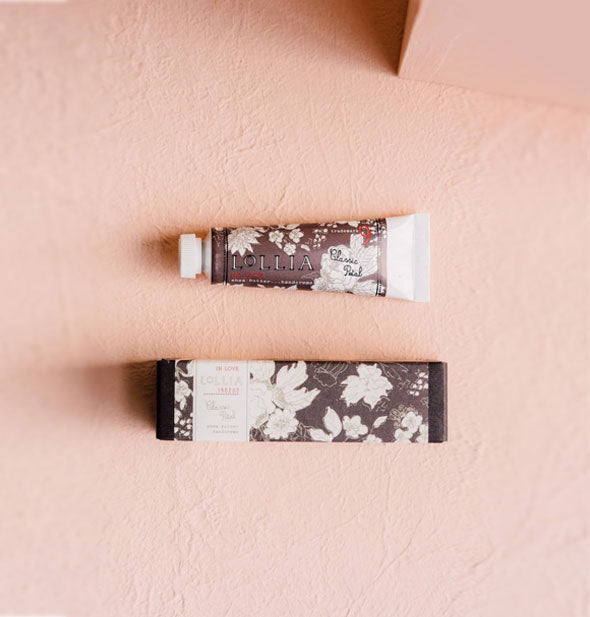 Mini tube and box of Lollia Classic Petal Handcreme both feature warm gray and white floral patterning
