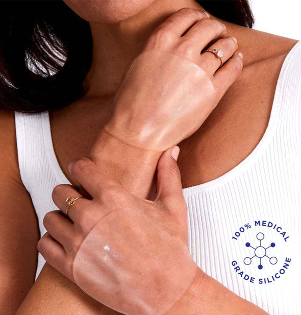 Model wears clear silicone patches on backs of hands; a seal with infographic in the lower right corner says, "100% medical grade silicone"
