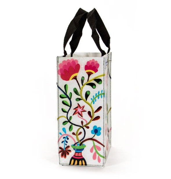 Side panel of tote bag features a colorful florals and vines design