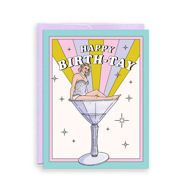 Greeting card backed by a purple envelope features illustration of Taylor Swift perched on a large cocktail glass under the message, "Happy Birth-Tay" in white lettering