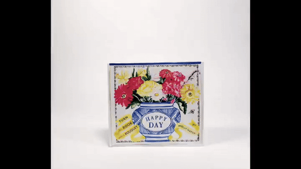 GIF demonstrates how the flowers in the Happy Day book can be lifted up to resemble a live bouquet in a vase