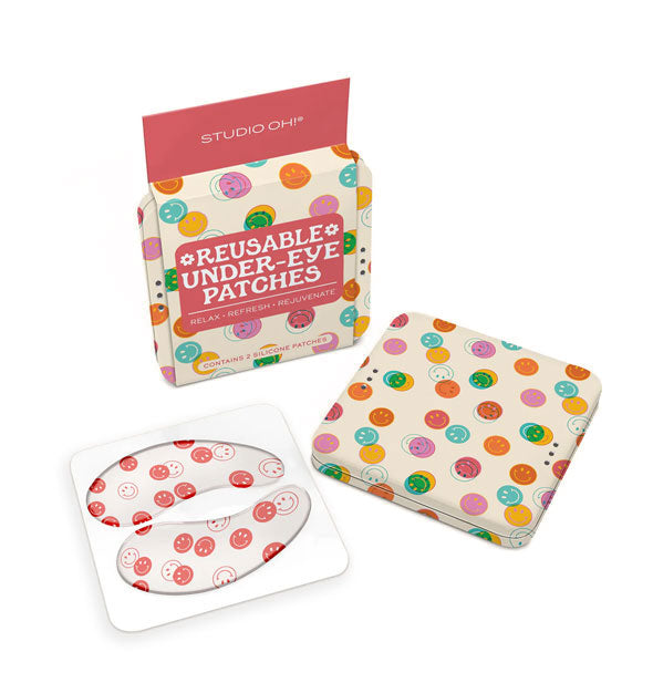 Contents of the Happy Vibes edition of Studio Oh! Reusable Under-Eye Patches: red and white smiley face print patches and multicolored smiley face square storage tin