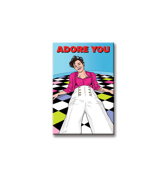 Rectangular magnet features illustration of Harry Styles laying on a colorful checkered floor against a blue background with the words, "Adore you" in bold red lettering at the top
