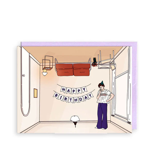 Greeting card backed by a purple envelope features illustration of Harry Styles' "Harry's House" upside-down room album cover with Happy Birthday banner on the back wall and a party hat on Harry's head